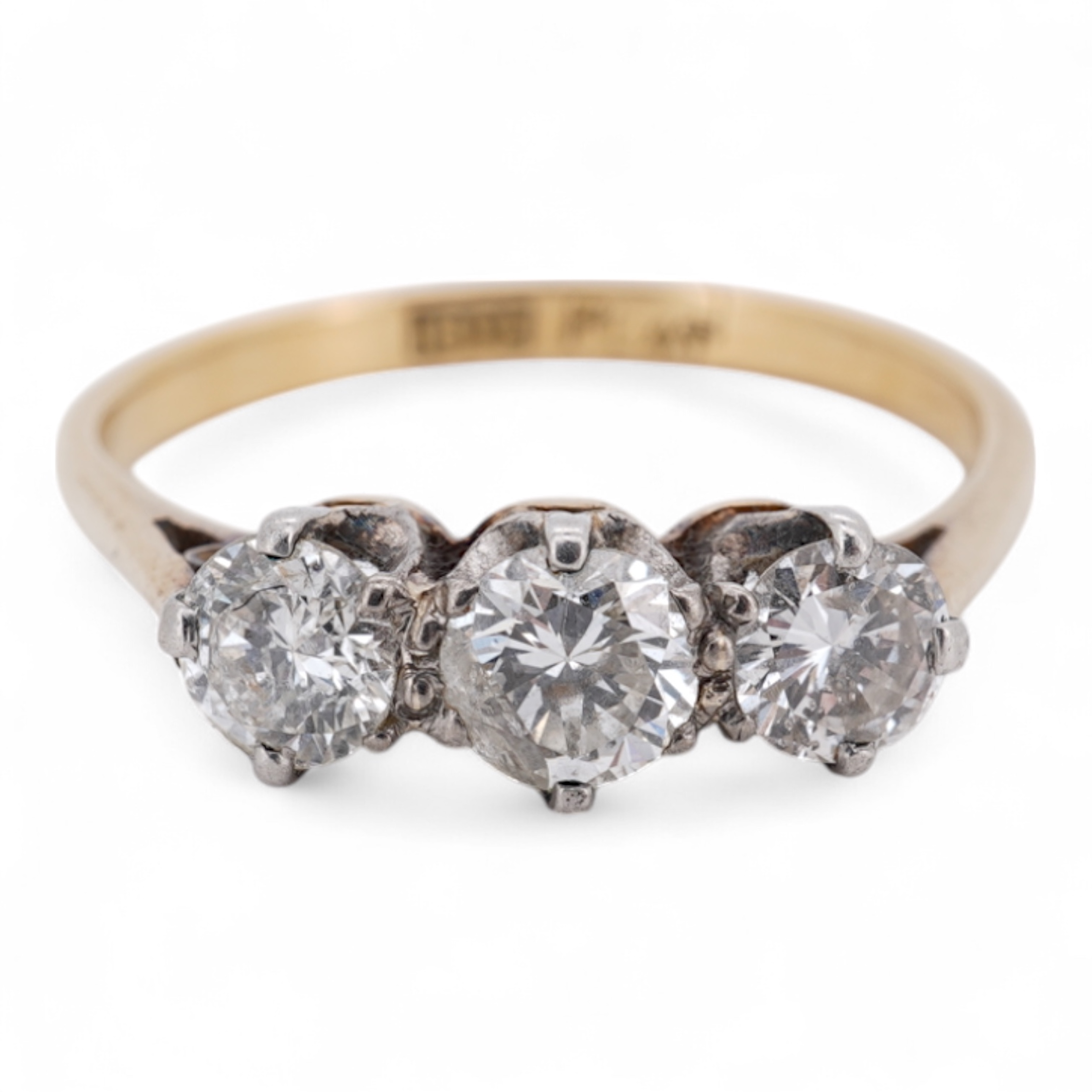 A yellow metal (stamped 18ct, & plat) and three stone diamond set ring, size L, gross weight 2.1 grams.